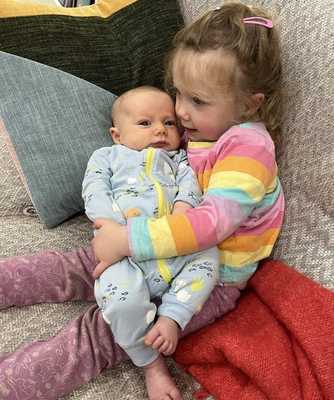 Ari getting a hug from his sister