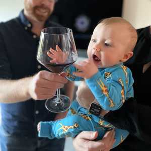 Attempting to try the wine at Thanksgiving